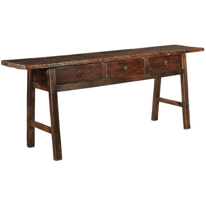The Tigris Console Butcher Table features reclaimed wood with a dark finish, three front drawers with metal handles, angled legs, and visible wood grain with distressed edges for a rustic, vintage look.