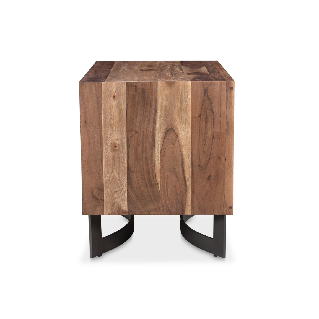 The Bentley Live-Edge Nightstand, made from solid acacia wood, showcases a rich mixed grain finish and stands on curved black metal legs. Its block-style, minimalist design highlights the unique natural wood pattern against a white backdrop.