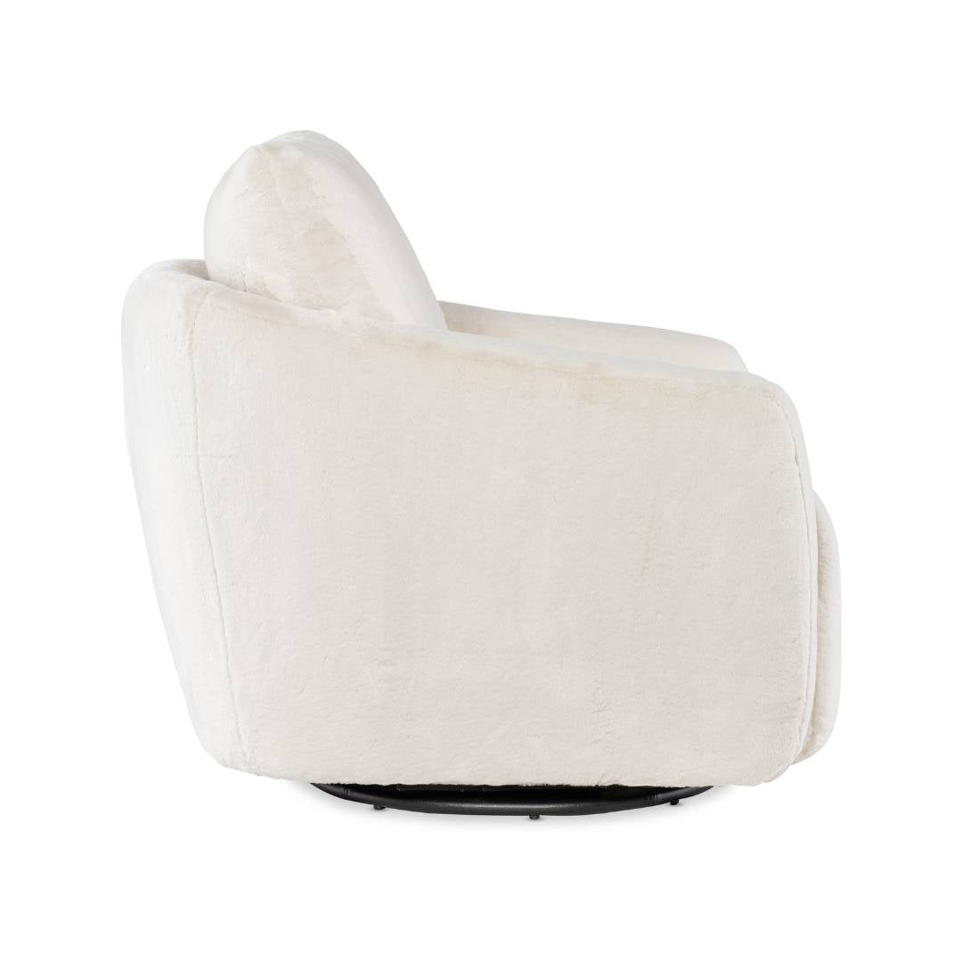 The Arista Swivel Chair with Power Footrest is shown from the side, featuring cream upholstery, a rounded back, plush seat, smooth silhouette, and a hidden circular swivel base against a white background.