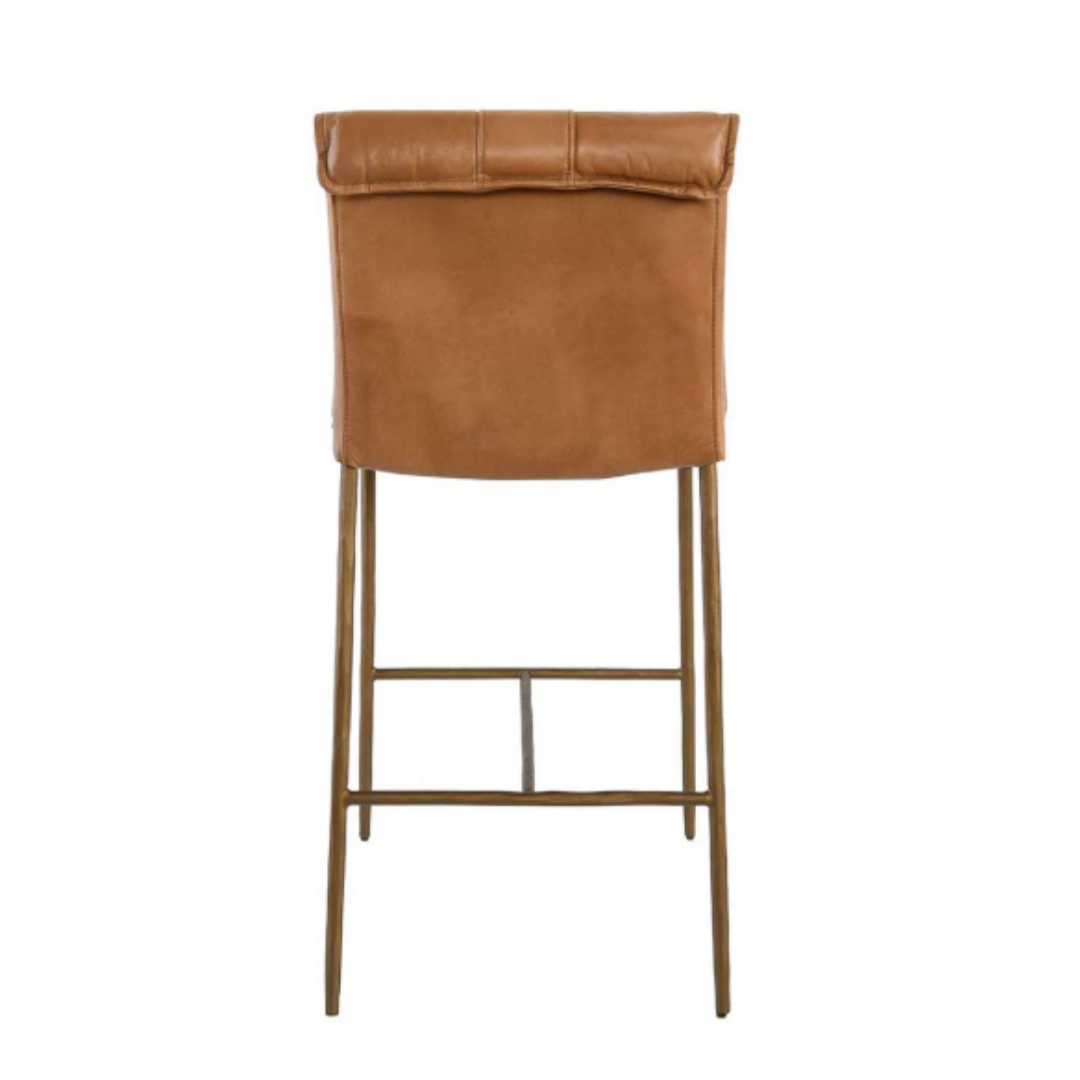 The Calder Leather Counter Stool features a cushioned seat and backrest in rich brown leather. Its sculptural metal frame has slim legs and a footrest also in brown, offering a modern, minimalist design.