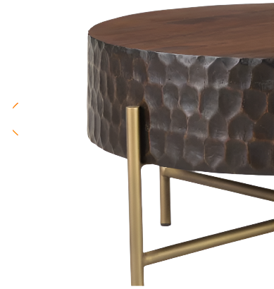 Close-up of a contemporary Cruz Coffee Table featuring a mango wood top with a textured, metallic base in a hammered finish and slender golden legs.