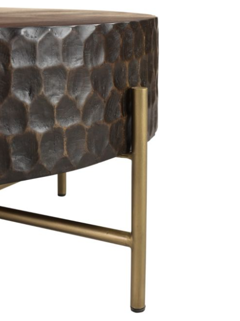 A close-up of the contemporary Infinity Coffee Table featuring a textured, mango wood surface resembling a hammered metal effect, supported by sleek, golden metallic legs with a simple horizontal crossbar.