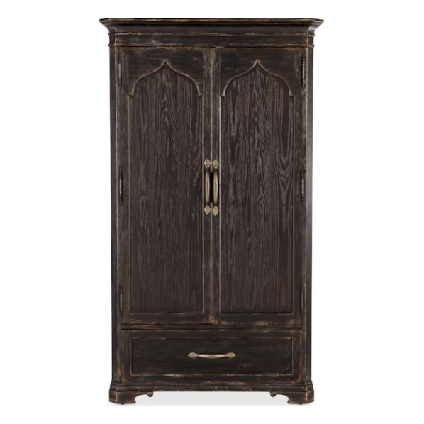 The Florence Wardrobe Cabinet is a tall, dark brown antique-finished piece with oak veneers, two doors featuring ornate molding and metal handles, a spacious bottom drawer, and short curved feet.