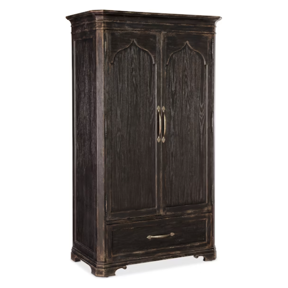 The Florence Wardrobe Cabinet is a tall, dark wood piece with a distressed finish, two ornate paneled doors with brass handles, a lower drawer, oak veneers, and decorative molding on the top and bottom edges.