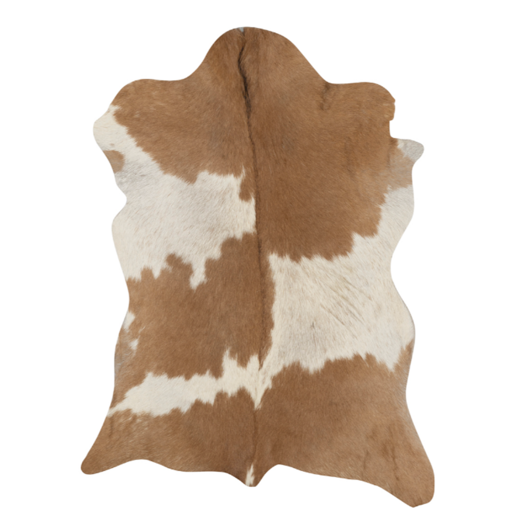 A Goat Hide Throw with rustic charm features an organic, asymmetrical shape and light brown and white patches unevenly distributed across its smooth surface. Noticeable hair detailing adds to its raw allure, while it lays flat for a natural appeal.