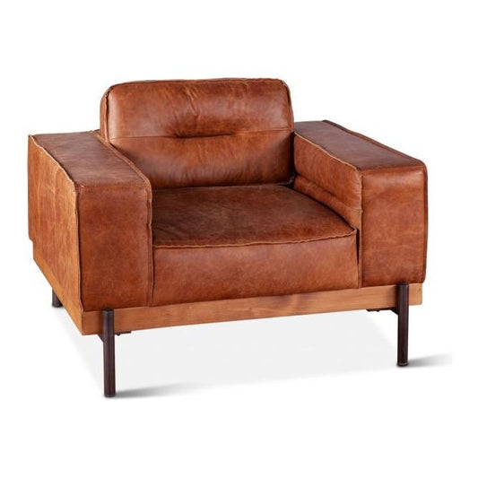 A vintage-style distressed antique Cocoa Leather Accent Chair with a boxy frame and wooden legs, isolated on a white background. The leather appears slightly worn, adding to its rustic charm.