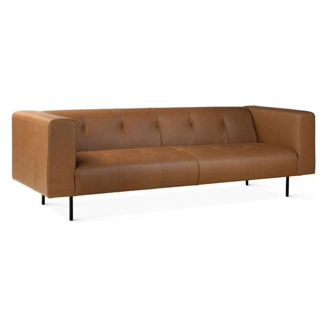 The Copper Leather Sofa is a luxurious brown leather piece with a modern minimalist design. It features three cushioned seats with subtle button tufting and square armrests, resting on four slender black metal legs for a sleek contemporary appeal.