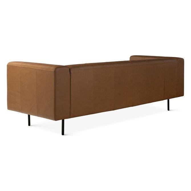 The Copper Leather Sofa is a modern high-end sofa featuring top grain leather, a minimalist boxy design with flat armrests and backrest. Elevated on slim black metal legs, it offers a sleek and contemporary look with smooth, finely crafted upholstery.