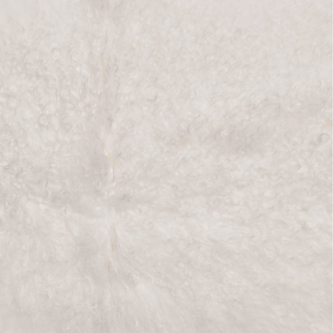 A close-up of the Lamb Fur Pillow reveals a soft, textured surface resembling white fluffy fur with a curly pattern reminiscent of Tibetan lamb fur. The plush and cozy fabric shows subtle curl variations, adding depth and warmth, while its neutral white color enhances the luxurious appearance.