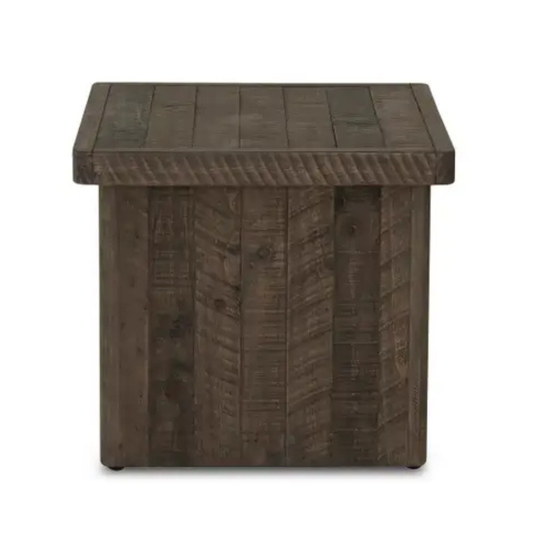 The Monte Wood Side Table is a square, rustic side table with a driftwood finish, visible wood grain, plank detailing on all sides, and a sturdy boxy shape that sits flush to the floor without visible legs or gaps.