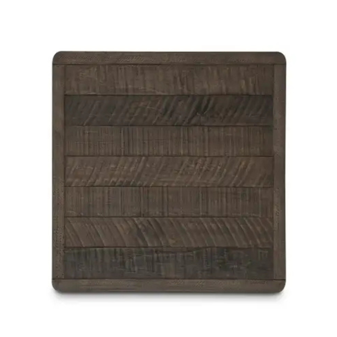 The Monte Wood Side Table features a square, dark wood tabletop with visible grain and a weathered driftwood finish. Horizontal planks show subtle color variations for a rustic, handcrafted look, with softly rounded corners against a white background.