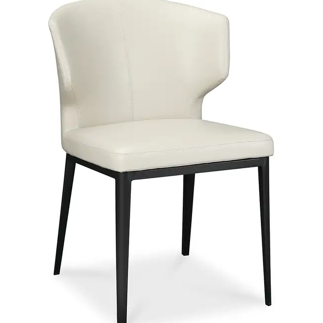The Randolph Dining Chair features a modern, elegant design with cream vegan leather upholstery, a curved back, and slender black metal legs. It provides versatile seating that enhances contemporary spaces with a minimalist aesthetic.
