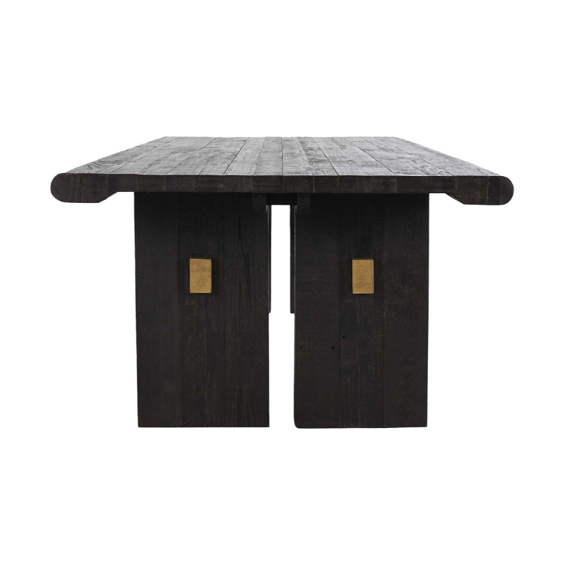 The Echo Reclaimed 96" Dining Table features a rectangular top made of reclaimed pine with a textured finish that highlights its visible wood grain patterns. It is supported by two wide, sturdy legs, each adorned with brass rectangular accents in the center, offering a blend of rustic charm and modern elegance.