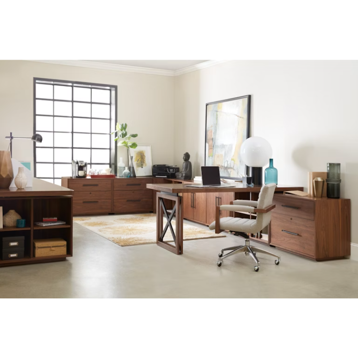 Modern home office featuring the Soren Walnut Lateral File, matching wooden cabinets and shelves, a modular desk with a locking drawer, white cushioned chair, abstract art, decor accents, large window, and neutral tones for a serene ambiance.