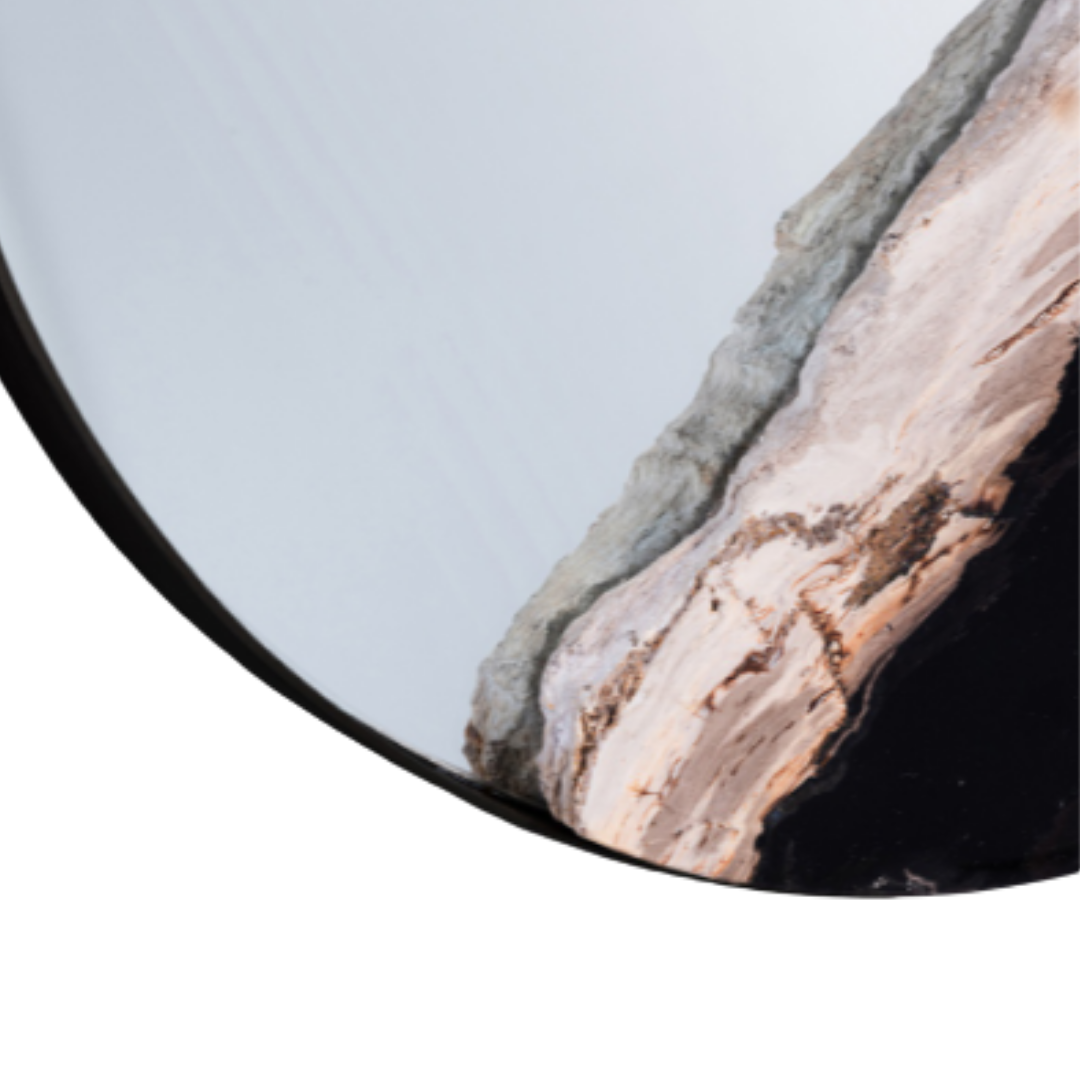 Close-up of the Thalor Petrified Wood Accent Mirror, featuring polished, smooth curved layers in white, gray, and light brown. Its mineral texture contrasts with a white background and thick black border along the left edge.