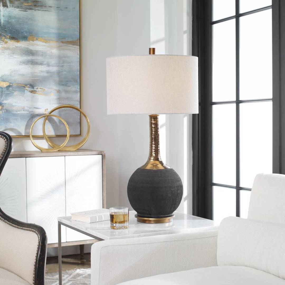 Decorative lamp on a side table with abstract art in the background