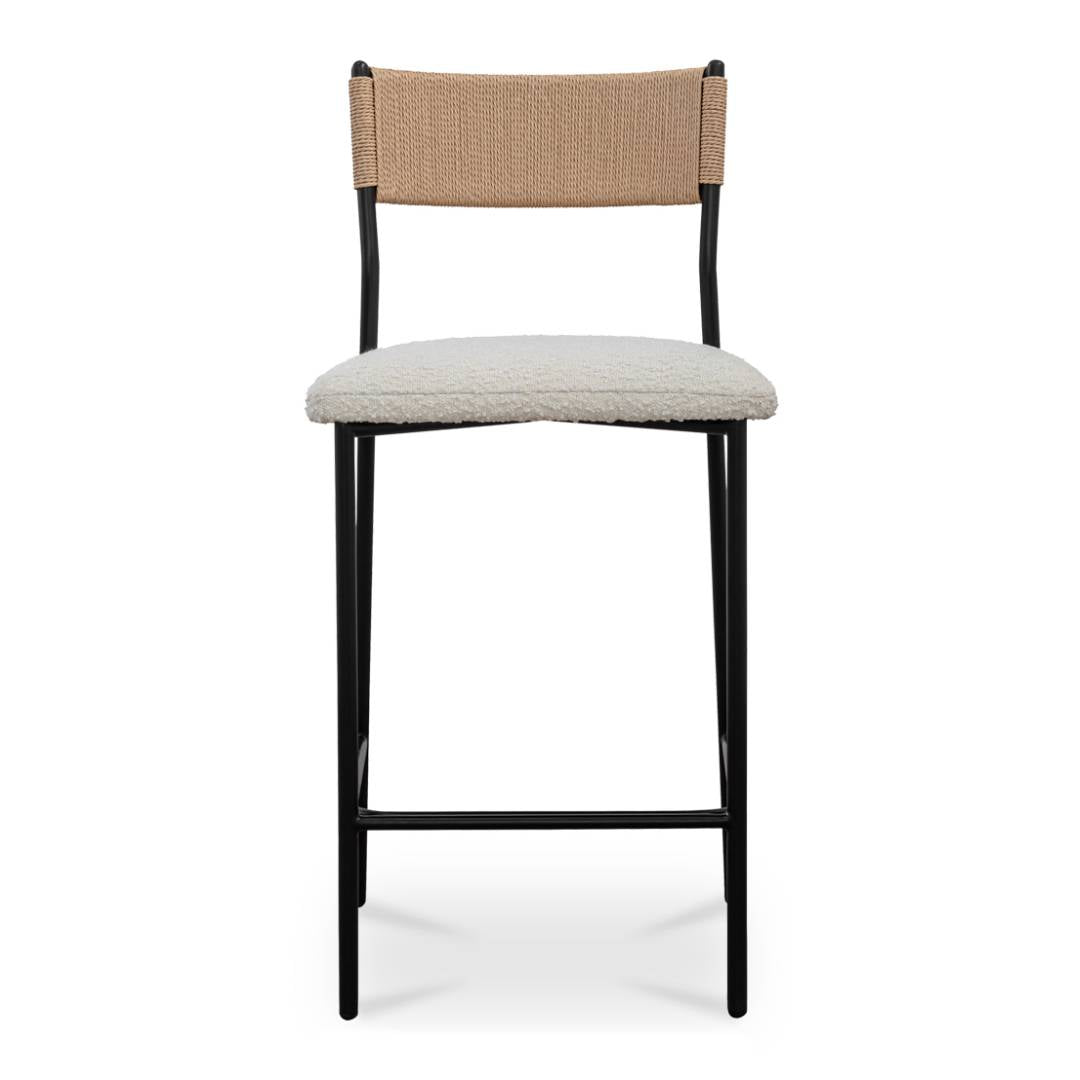 The Soren Performance Fabric Counter Stool features a black metal frame, woven tan paper rope back, off-white performance fabric seat, minimalist four-leg design, and a front footrest.