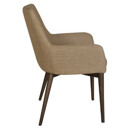 A side view of a Franny Arm Dining Chair with a beige fabric covering and a high backrest. The chair has smooth, curved armrests and dark ash wood legs tapering towards the floor, adding a sleek and contemporary touch to the design, perfect for pairing with your dining table.