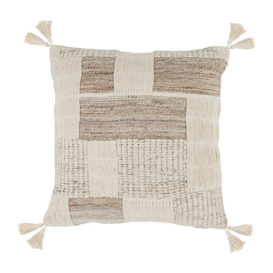 Lamar Throw Pillow with a neutral color scheme. The cushion features a patchwork design with various textures including knit, woven, and smooth sections. Enhanced with hand-embroidery block design and cream-colored tassels at each corner, it exudes a cozy and rustic aesthetic.