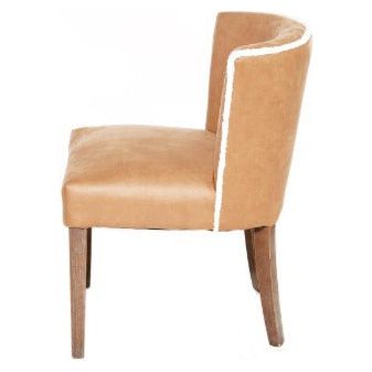 A side view of a Shearling Dining Chair with smooth tan leather upholstery and dark wooden legs. The chair features unique white stitching detail along the outer edge of its curved backrest and seat.