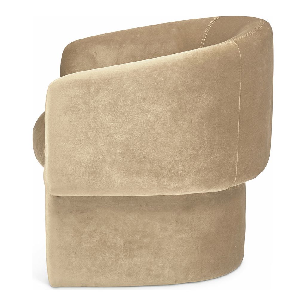 A plush, beige James Velvet Accent Chair with a soft, velvet-upholstered texture and rounded armrests, featuring visible stitching details. The chair has a circular base and a modern, compact silhouette.