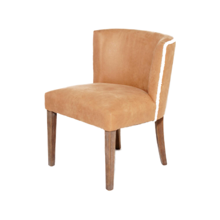 A modern Shearling Dining Chair with rounded back and light brown suede upholstery. The chair features a plush seat and a slightly curved backrest, set on four wooden legs with a natural finish.