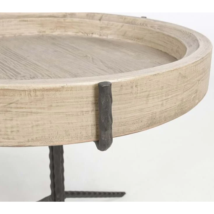 Close-up of the Lucinda Nesting Tables, showcasing their round wooden design with a light, textured surface. Elegant black metal accents decorate the edges, giving them a rustic flair. The hammered metal legs contrast beautifully with the wooden top, allowing these tables to complement shorter nesting tables for a versatile arrangement.
