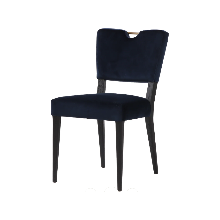A modern Gold Handle Dining Chair with a sleek design. It features a dark blue, easy-to-maintain velvet-upholstered seat and backrest. The backrest has a subtle V-shaped notch at the top and a small gold accent handle. The chair stands on four black, tapered wooden legs.
