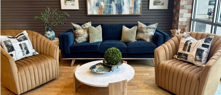 blue sofa with 2 golden swivel accent chairs