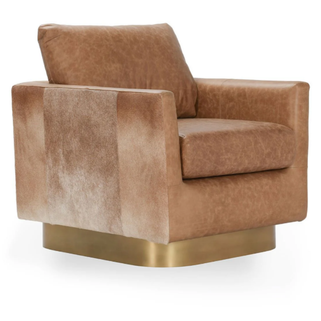 The Velancia Hide & Leather Swivel Chair is a luxurious brown top grain leather armchair with a square design, complemented by plush cushions and a sleek curved brass base. Its textured leather and rich color exude modern glamour, while the slightly reclined backrest enhances comfort.