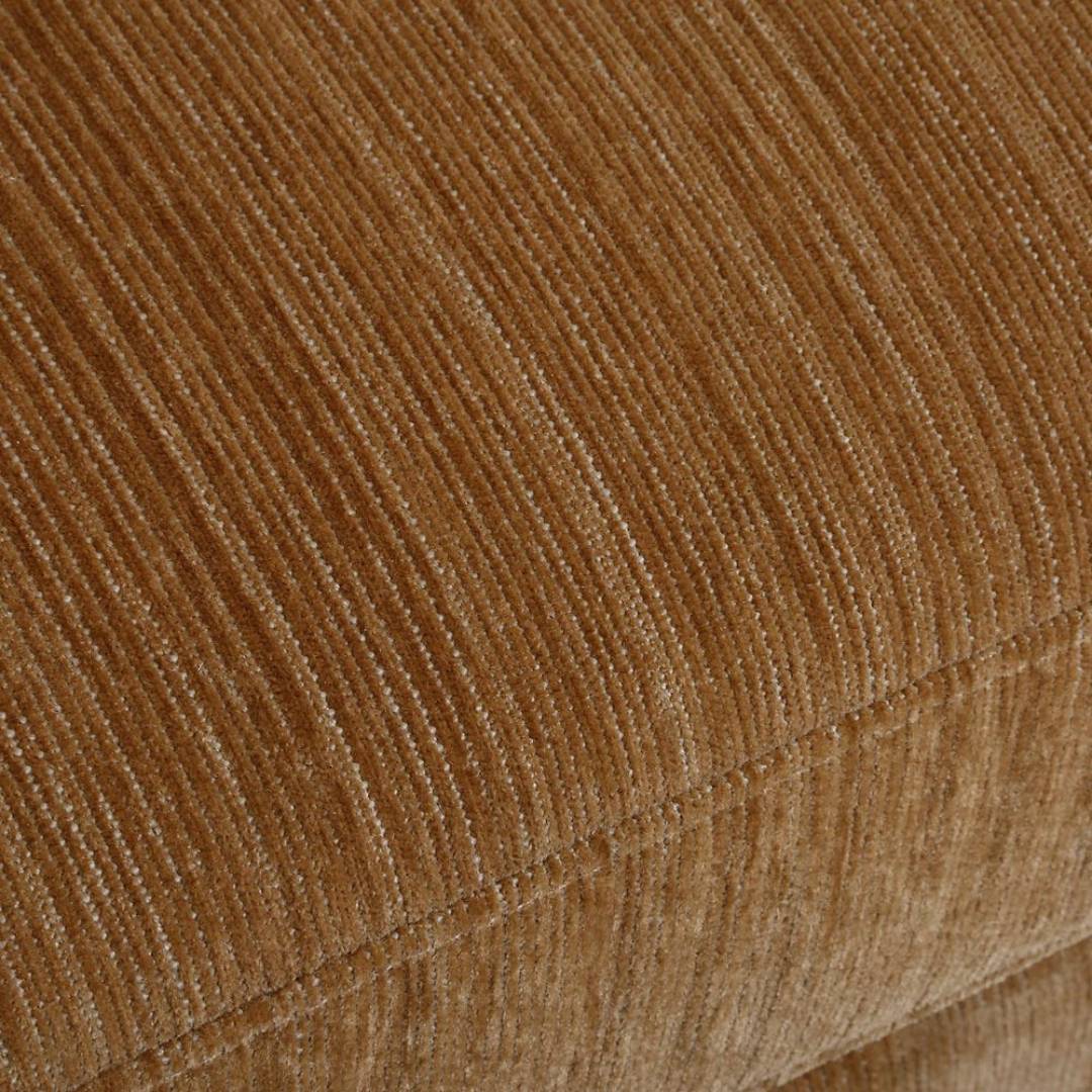 Close-up of textured, light brown corduroy with vertical ridges, ideal for upholstery on pieces like the Solana Swivel Accent Chair, Ginger, where sculptural curves meet plush comfort.