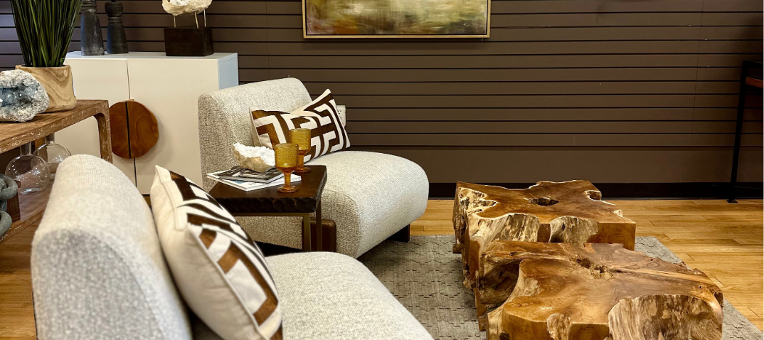 picture of a high end furniture store showroom. two white boucle accent chairs with erosion wood coffee tables