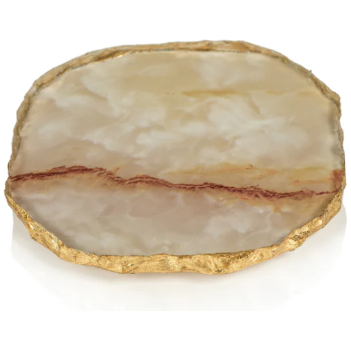 The Agate Marble Glass Coaster, Yellow Orange, offers a glossy design in shades of cream and brown with unique marbling. Its raised, textured gold rim surrounds the smooth surface, showcasing distinctive veining with a prominent brown line running through the center against a plain white background.