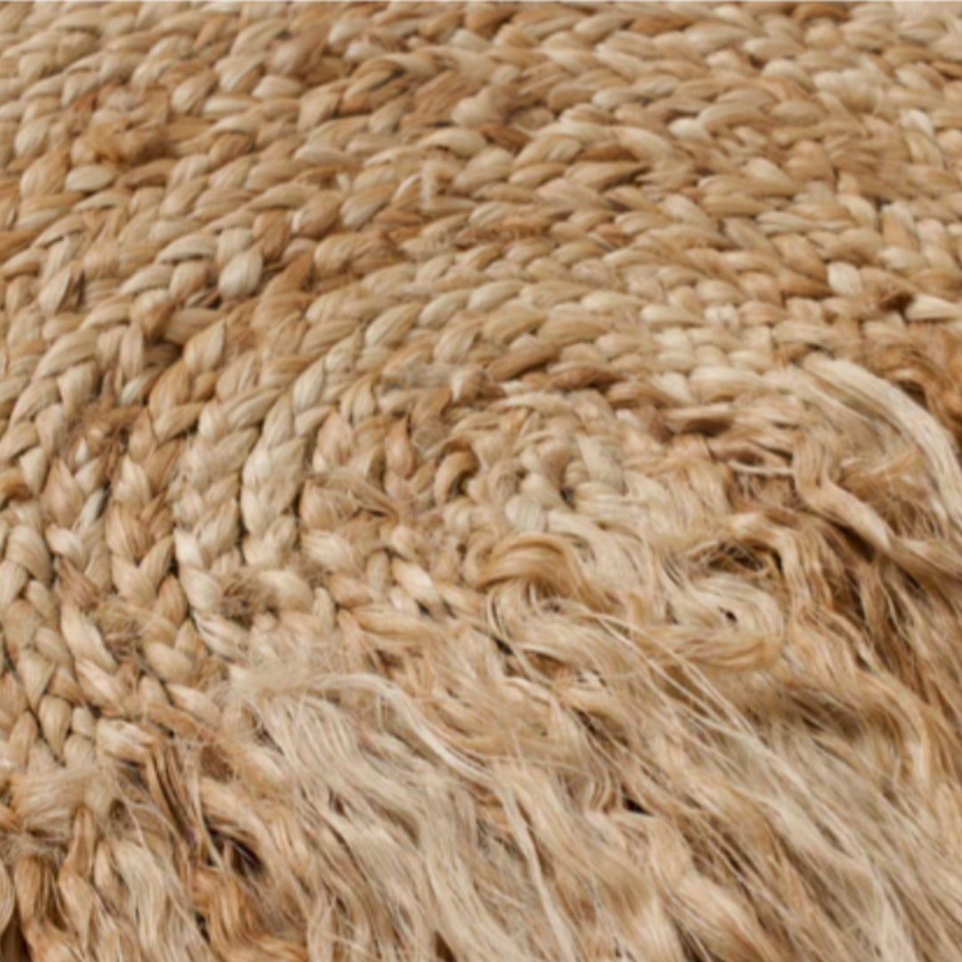 Close-up of the Bellmont Braided Wool Boho Wall Art reveals tightly woven, earthy-toned patterns. Smooth braids contrast with frayed fibers, emphasizing its rustic, natural texture and handcrafted design.