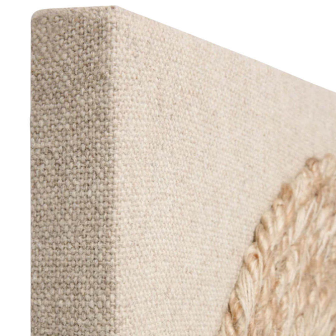 Close-up of the corner of the Bellmont Woven Wool Boho Wall Art, featuring a beige textured canvas with a raised coiled rope on the right. The woven wool and natural fiber rope create unique, organic visual interest for your space.