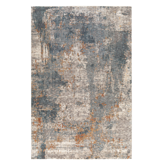 The Candice Machine Woven Rug features a contemporary, medium pile with an abstract, distressed pattern in muted gray, blue, and rust orange. Its uneven color blend creates a textured, weathered look inspired by worn stone or aged paint.