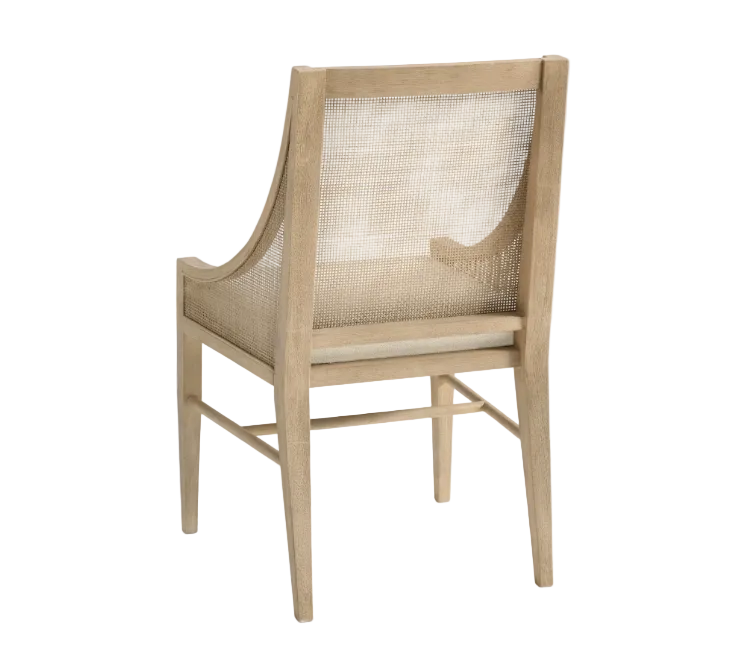 A light natural wood dining chair with a woven cane backrest and seat, shown from a three-quarter angle on a white background.