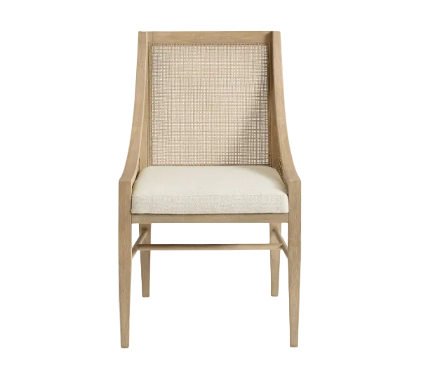 A light oak dining chair with a woven cane backrest and a cream-colored upholstered seat cushion, shown against a plain white background.