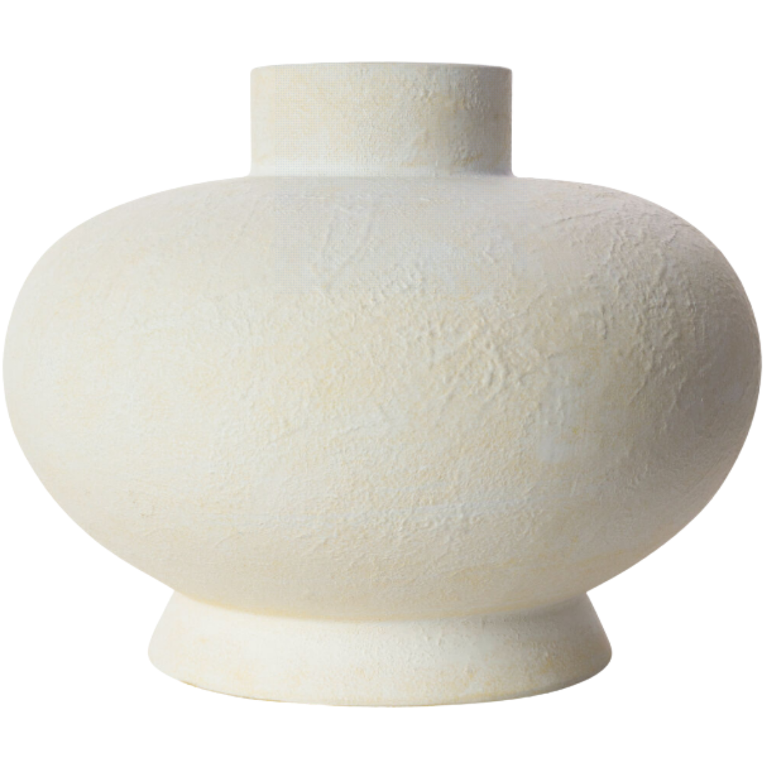 The Cavera White Ceramic Vase features a round, wide body with an off-white ceramic finish, narrow short neck, and slightly flared base. Its rough matte texture creates a handcrafted, rustic look, free of handles or added decoration.
