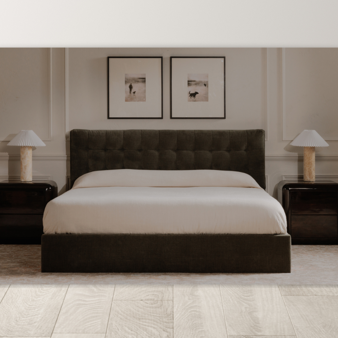 A modern bedroom showcases the Corveline Green Storage Bed with a tufted headboard, white bedding, two dark wood nightstands with matching lamps, framed photos above, and light wood floors for a calm, minimalist atmosphere.