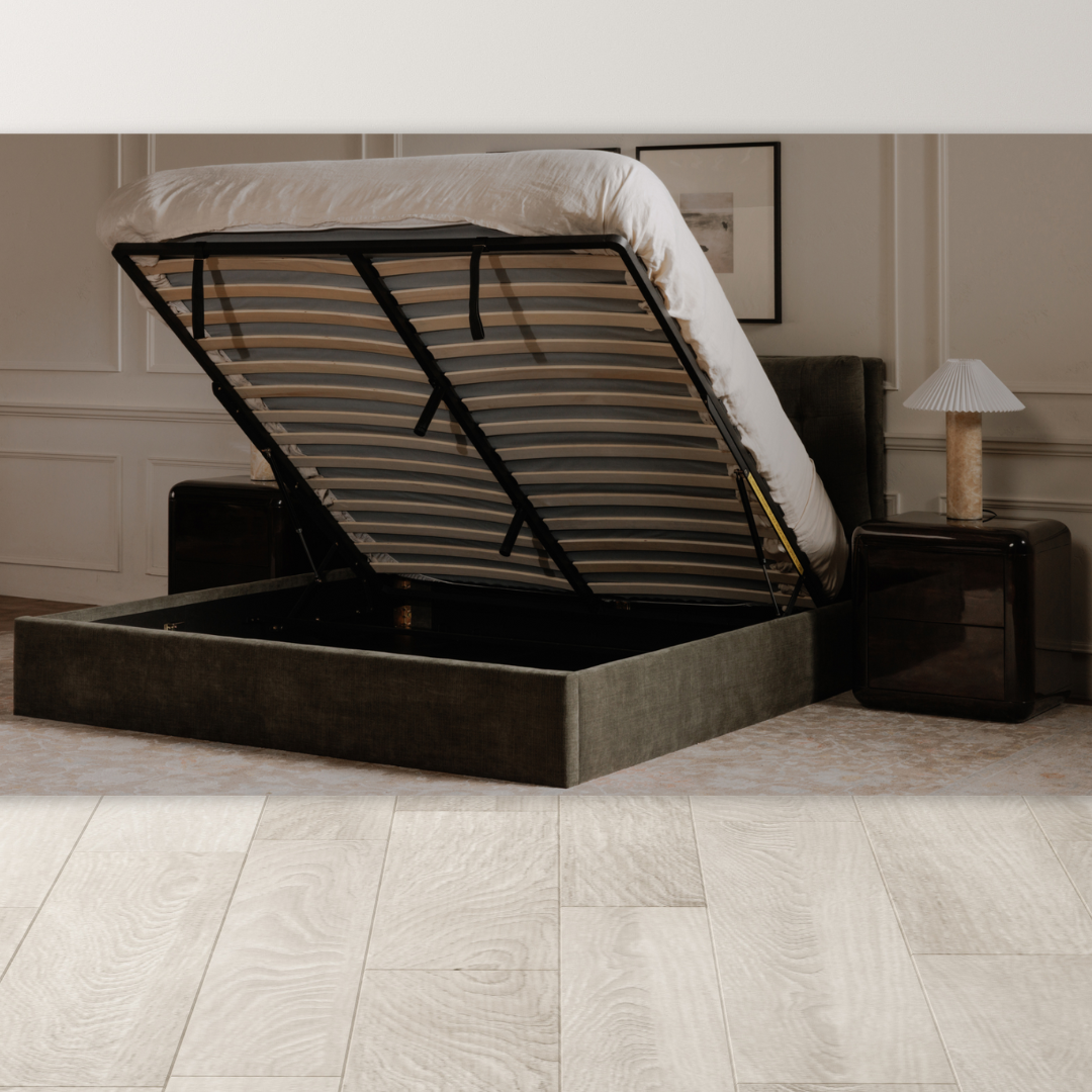 A modern bedroom features the Corveline Green Storage Bed with a hydraulic lift base for storage. The space is completed with two dark nightstands, lamps, neutral walls, framed art, and a light rug for cozy minimalism.