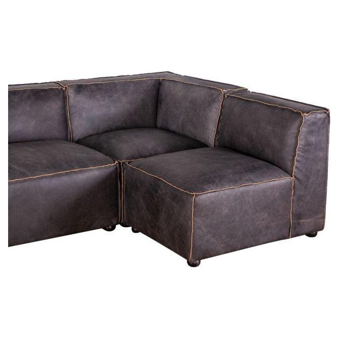 Antique Ebony Leather Sofa upholstered in distressed antique leather, featuring prominent beige stitching along the edges, and cushioned backs and seats. The sofa has a low-profile design with a sleek, contemporary look.