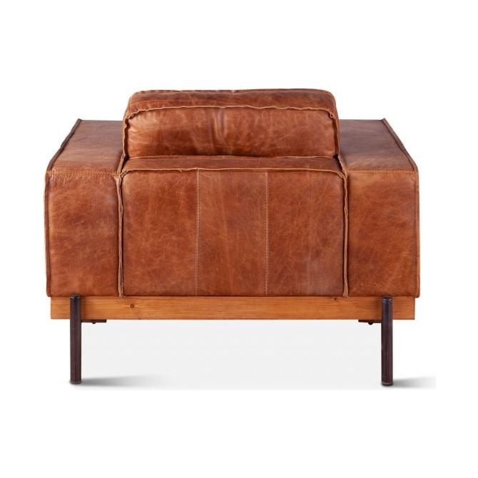 A Cocoa leather accent chair with a smooth brown finish. The chair features a padded backrest and square arms supported by a sleek wooden frame, giving it a classic yet robust appearance, isolated on a white background.
