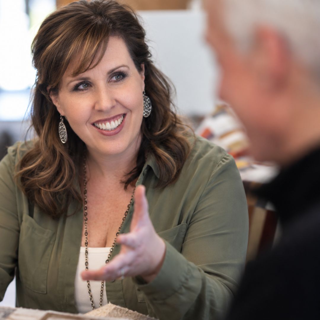 Interior designer Jaime Cawthron discussing design decisions with a client during an in-home design session.
