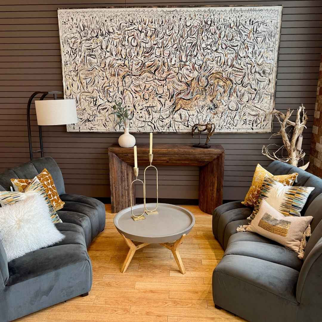 Original abstract art for sale by Kader Boly, featuring a large textured canvas with a handcrafted black frame, styled in a modern living room setting.