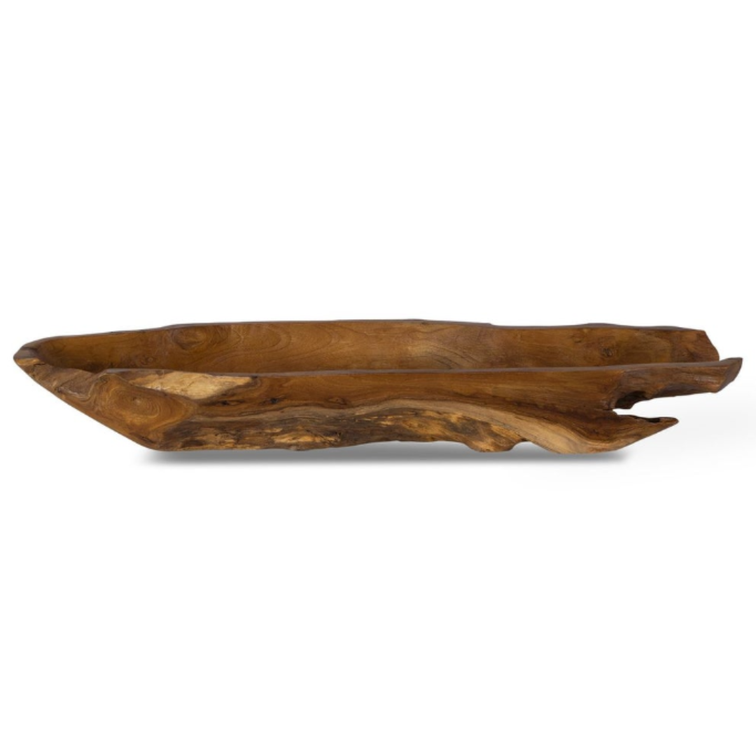 The Luvira Teak Leaf Bowl is a rustic, elongated wooden bowl made from natural teak wood, featuring a rich dark grain with unique characteristics. Its rugged edges highlight its handcrafted appeal, and the variations in the finish emphasize its organic texture and shape against a white background.