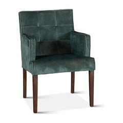A green velvet armchair with a birchwood frame and brown legs, featuring a high backrest and a seat cushion.