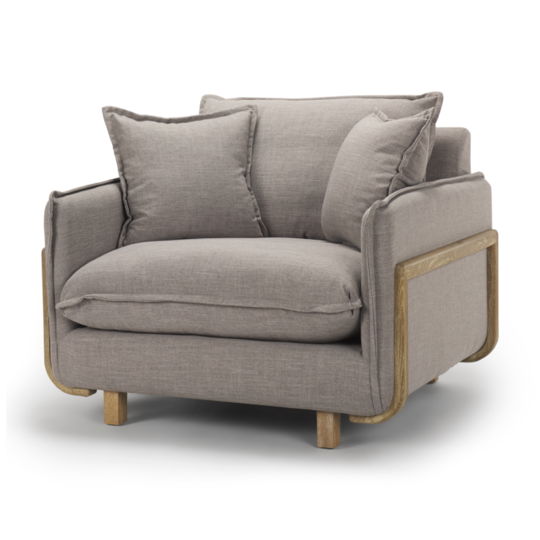 The Veyra Plush Upholstered Armchair in Earthy Grey is a modern comfort masterpiece with grey fabric and a light brown wooden frame. Its plush back, seat cushions, and two pillows offer elegance with curved accents and sturdy legs for an exquisite statement piece.