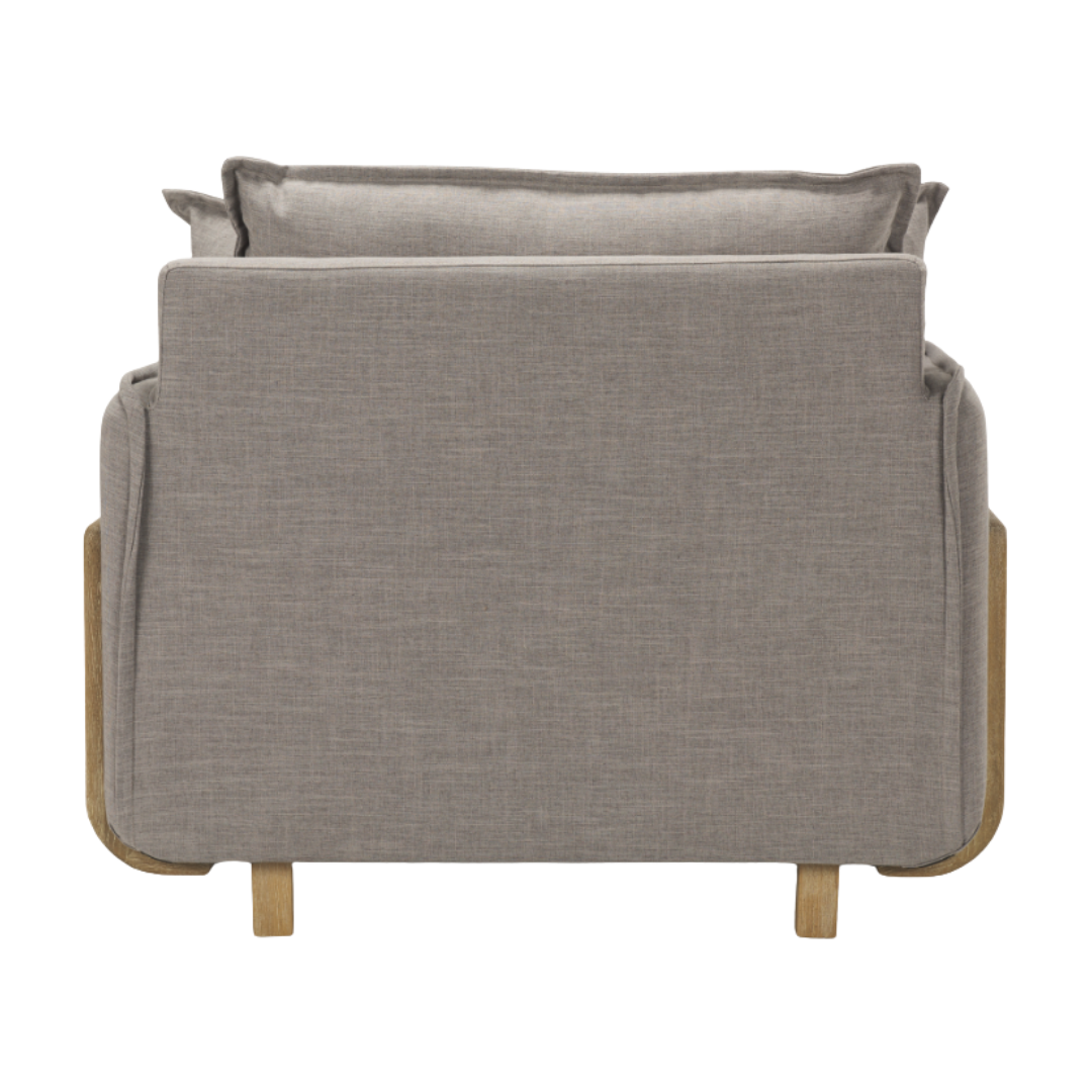 The Veyra Plush Upholstered Armchair in Earthy Grey, shown from the back, displays a boxy design with minimalist style, plush cushions, wooden legs, and subtly rounded corners. Its light wood frame contrasts beautifully with the fabric for a modern comfort statement piece.