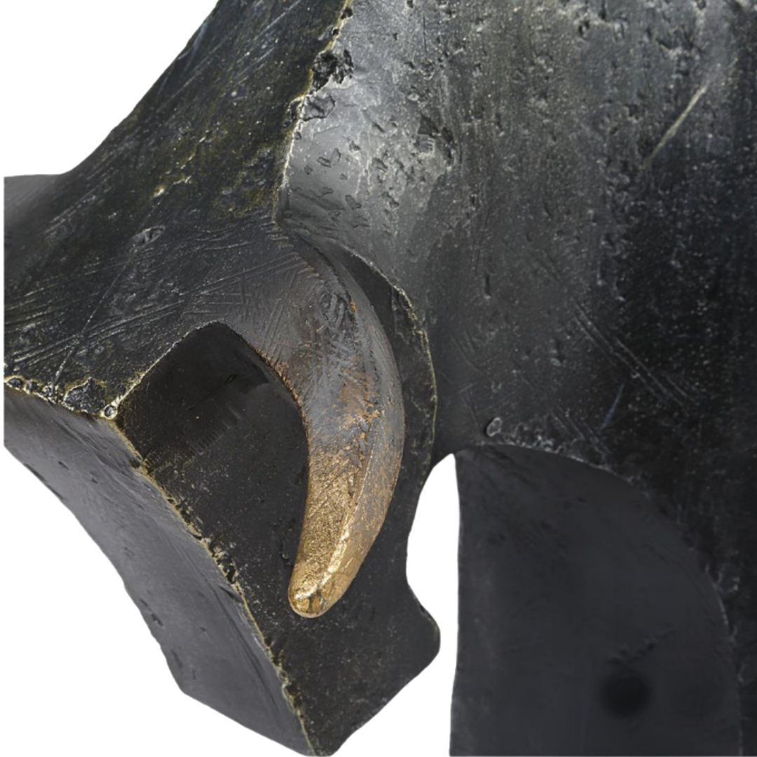 Close-up of the Noble Bull Statue, a decorative piece in dark bronze with a smooth golden accent emerging from its textured black surface. Visible marks add depth, and gold highlights create an abstract, modern design.